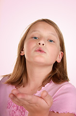 Image showing young girl blowing a kiss