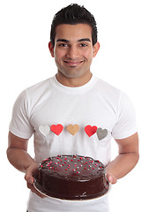 Image showing Man carrying romantic heart cake