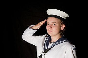 Image showing navy seaman saluting on black