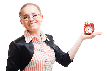 Image showing Young positive woman with alarm clock