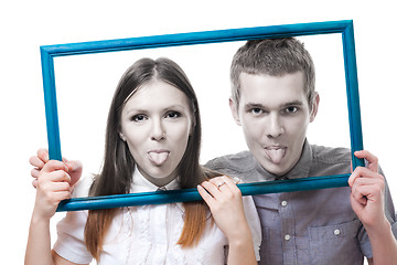 Image showing Couple look from frame with stick out tongue