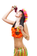 Image showing Woman eat grapes wearing bikini made of flowers