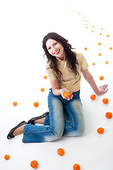 Image showing tangerine fantasy  - woman sit on a road of tangerine