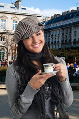 Image showing Young woman drink coffee in France