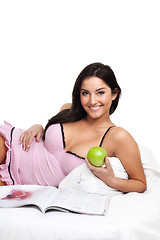 Image showing Happy young woman in read bed