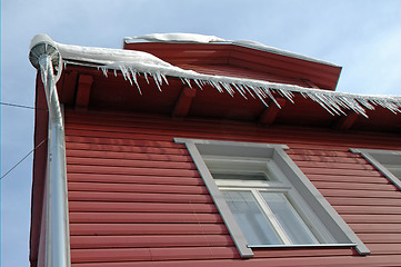 Image showing Icicles hanging from roof on idyllic wood house