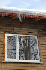 Image showing Icicles hanging from roof on idyllic wood house