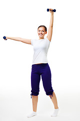 Image showing Happy young woman exercise with dumbbells