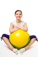 Image showing Happy young woman sit with fitness ball