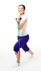 Image showing Young woman doing exercises with expander