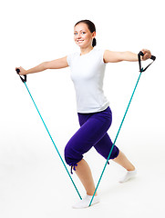 Image showing Young woman doing fitness with expander
