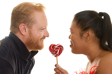 Image showing Two people share a candy