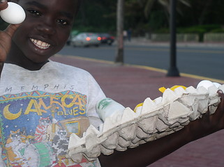 Image showing Child selling eggs