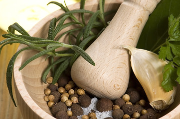 Image showing Mortar with fresh herbs and allspice berries