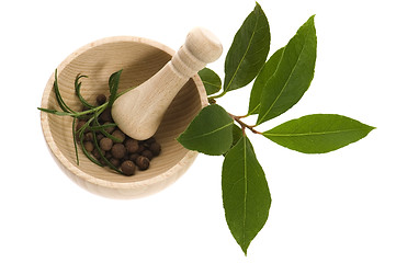 Image showing Mortar with fresh herbs and allspice berries