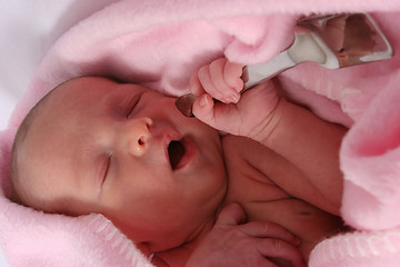 Image showing Baby born with silver spoon in her mouth