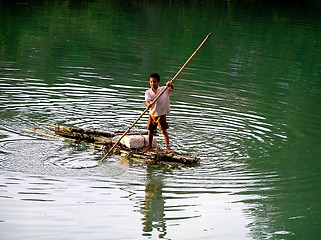 Image showing young thai on a wooden raft