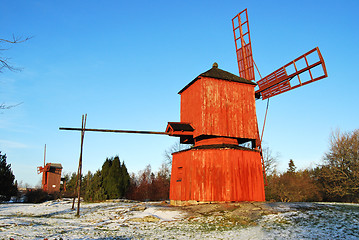 Image showing Two Red Wooden Windmills