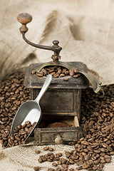 Image showing Old coffee grinder with coffee beans