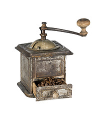 Image showing Old coffee grinder with coffee beans isolated