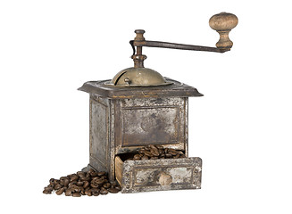 Image showing Old coffee grinder with coffee beans isolated