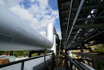 Image showing  industrial pipelines on pipe-bridge against blue sky