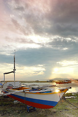Image showing Fishing boat on sunset beach