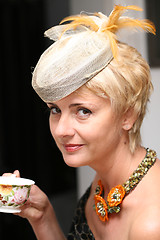 Image showing portrait of woman in hat with feathers and cup of tea