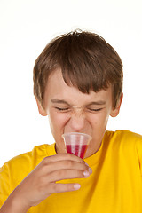 Image showing boy drinking medicine on white