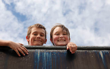 Image showing brother and sister on wall