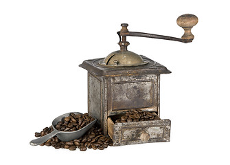 Image showing Old coffee grinder with coffee beans isolated