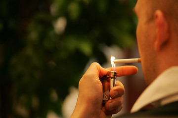 Image showing Lighting a cigarette