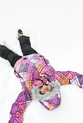 Image showing Girl making snow angel