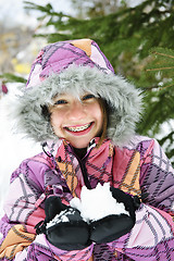 Image showing Happy winter girl holding snow