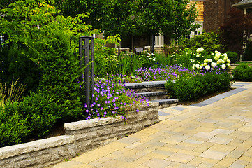 Image showing Landscaped  garden and stone paved driveway