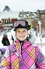 Image showing Happy girl in ski helmet at winter resort