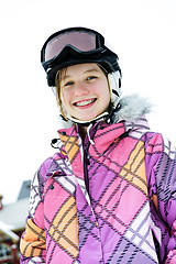 Image showing Happy girl in ski helmet at winter resort