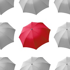 Image showing Red umbrella among white