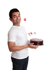 Image showing Cheeky man with a love heart cake