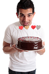 Image showing Cheeky man with a birthday cake