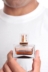 Image showing Man holding perfume aftershave