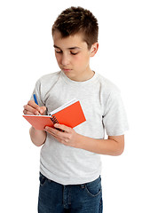 Image showing School boy writing in book