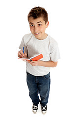 Image showing Boy looking up from a book and smiling