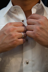 Image showing Wedding Groom buttoning shirt