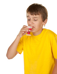 Image showing boy drinking medicine on white