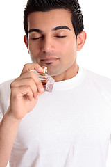 Image showing Man or customer smelling perfume  cologne