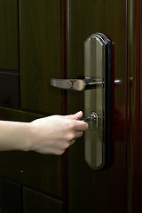 Image showing Opening the door