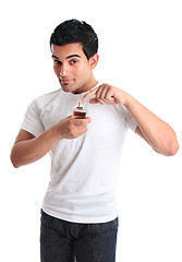 Image showing Man pointing to a bottle of perfume