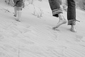 Image showing running father and kid - toes in sand