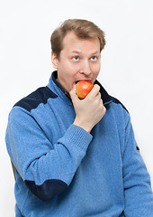 Image showing Man blond eats apple